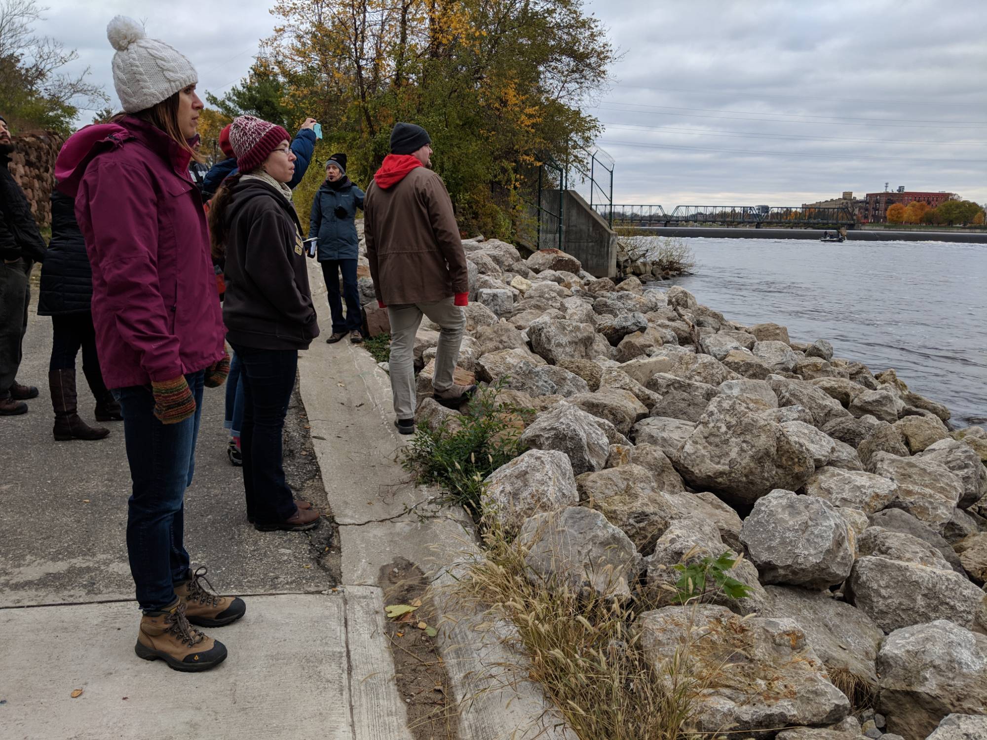 People looking at rock hardened shoreline